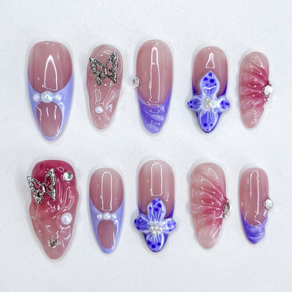 Butterfly Veil press-on nails with ombre hues, hand-crafted butterfly charms, and luminous floral accents for a graceful, romantic look.