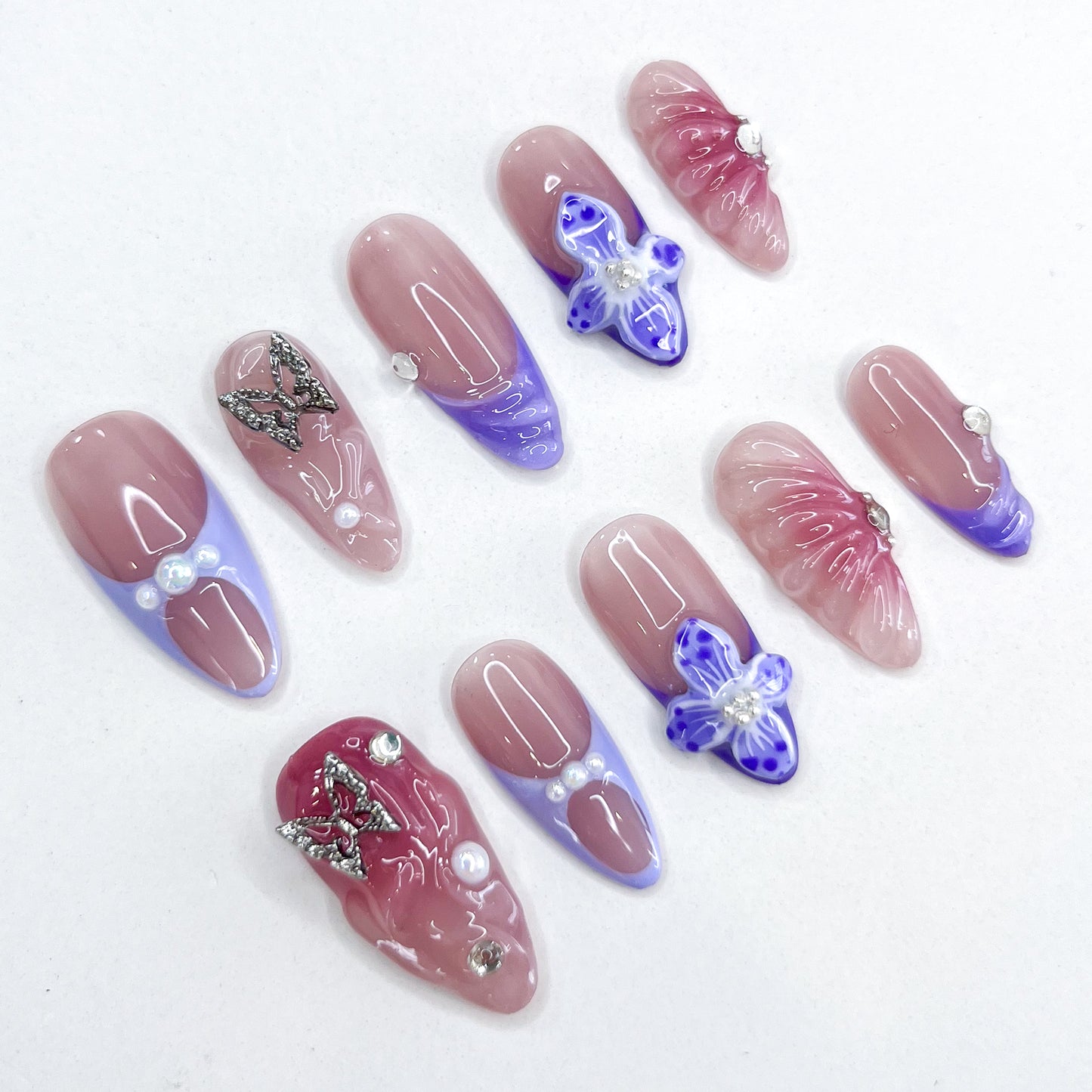 Butterfly Veil press-on nails with ombre hues, hand-crafted butterfly charms, and luminous floral accents for a graceful, romantic look.