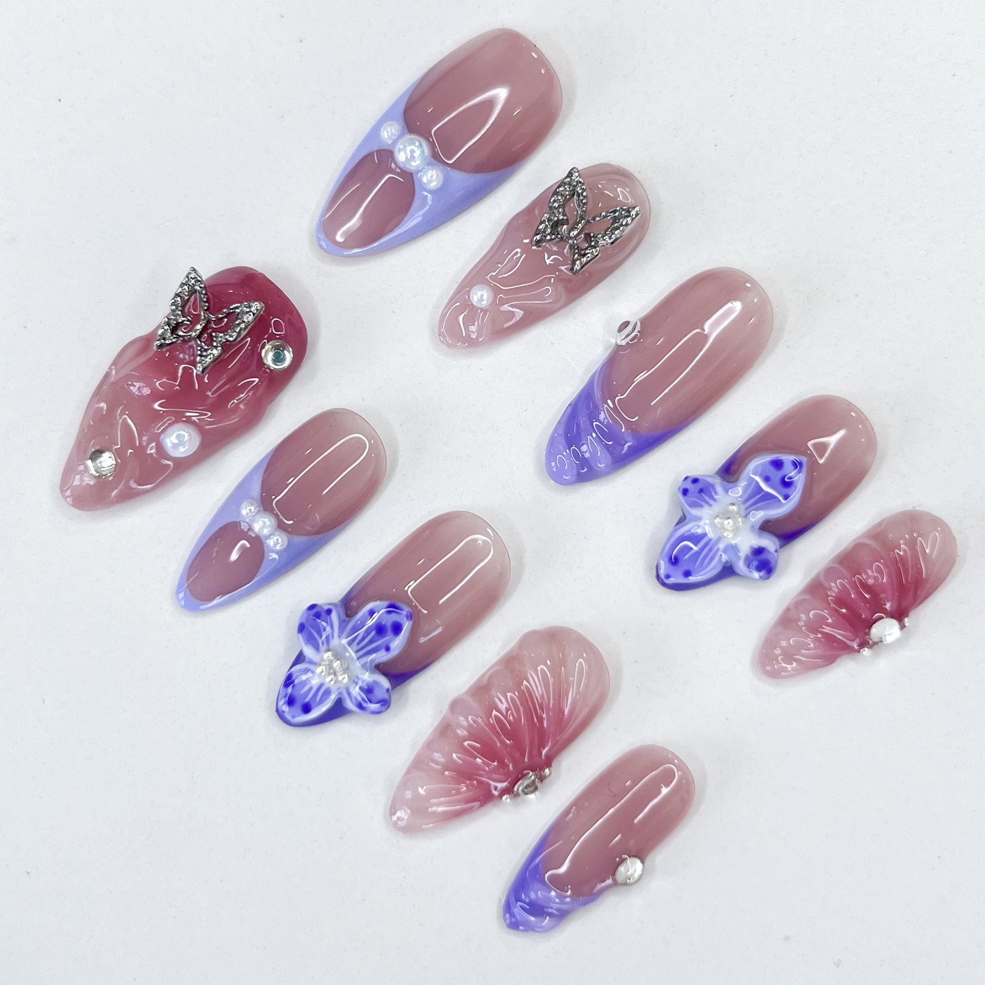 Butterfly Veil press-on nails with ombre hues, hand-crafted butterfly charms, and luminous floral accents for a graceful, romantic look.