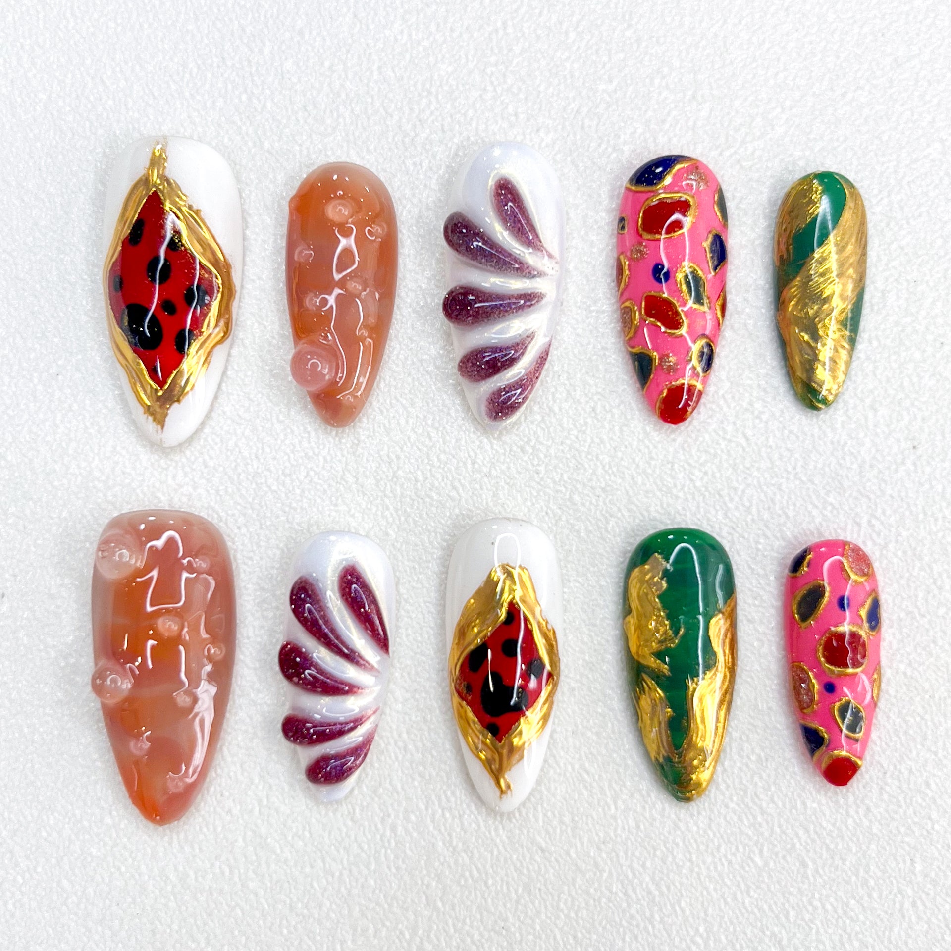 Rosy Flame press-on nails with radiant pink and red tones, intricate hand-painted flowers, and golden highlights for a striking, confident look.