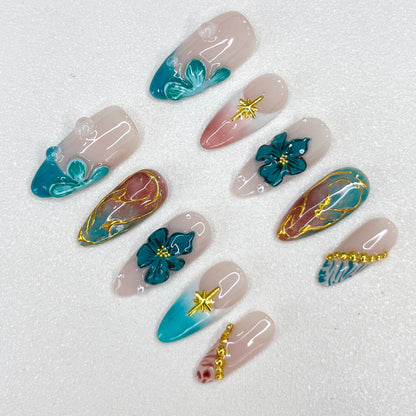 Tidal Serenity press-on nails with coastal-inspired tones, floral patterns, and golden details for a fresh and breezy aesthetic.