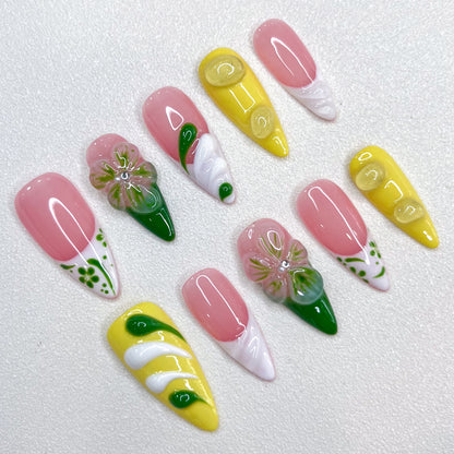 Lemon Fresh press-on nails with pastel yellow tones, swirling green designs, and subtle leaf patterns that evoke a bright and sunny vibe.