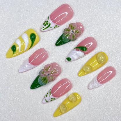 Lemon Fresh press-on nails with pastel yellow tones, swirling green designs, and subtle leaf patterns that evoke a bright and sunny vibe.