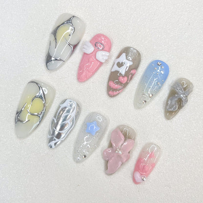 Celestial Dreams press-on nails with soft blue tones, metallic silver accents, and celestial-inspired moon and star decorations for a heavenly finish.