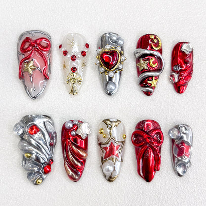 A festive set of press-on nails with red, silver, and gold tones, decorated with 3D bows, star motifs, pearls, and metallic accents. The design is luxurious and celebratory, ideal for holidays or special occasions.