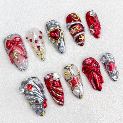 A festive set of press-on nails with red, silver, and gold tones, decorated with 3D bows, star motifs, pearls, and metallic accents. The design is luxurious and celebratory, ideal for holidays or special occasions.