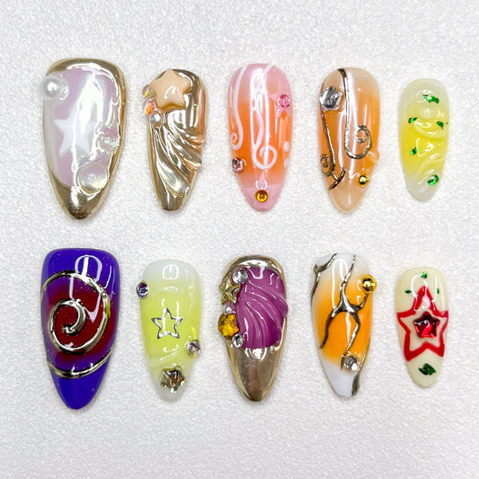 Galaxy-inspired press-on nails with star motifs, music notes, swirl designs, and metallic accents. Features shades of purple, gold, yellow, and orange, blended with celestial themes and 3D embellishments.