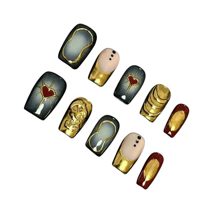 A set of luxurious press-on nails featuring gold accents, red heart motifs, and vintage-inspired designs, combining black, gold, and red hues for an elegant and regal look.