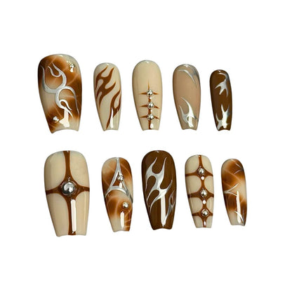 A press-on nail set featuring warm earthy tones, flame designs, geometric accents, and rhinestones, offering a chic and sophisticated aesthetic.