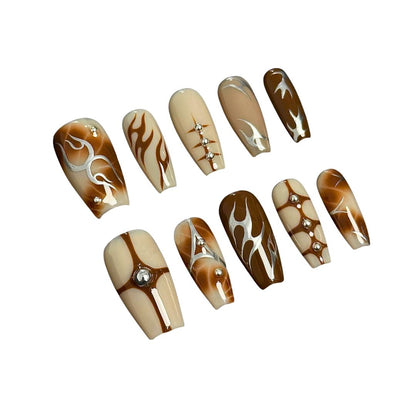 A press-on nail set featuring warm earthy tones, flame designs, geometric accents, and rhinestones, offering a chic and sophisticated aesthetic.