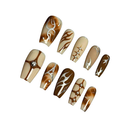 A press-on nail set featuring warm earthy tones, flame designs, geometric accents, and rhinestones, offering a chic and sophisticated aesthetic.