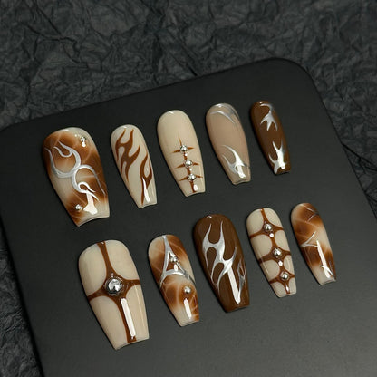 A press-on nail set featuring warm earthy tones, flame designs, geometric accents, and rhinestones, offering a chic and sophisticated aesthetic.