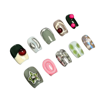 A press-on nail set featuring earthy greens, metallic silver details, and vibrant 3D elements like bows and stars, creating a modern and eclectic aesthetic.