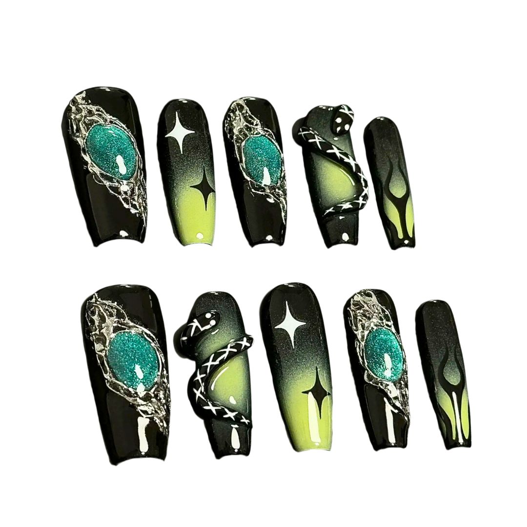 A press-on nail set featuring black and green gradients, metallic silver details, star motifs, and striking 3D embellishments, creating a mysterious and enchanting design.