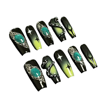 A press-on nail set featuring black and green gradients, metallic silver details, star motifs, and striking 3D embellishments, creating a mysterious and enchanting design.