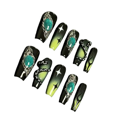 A press-on nail set featuring black and green gradients, metallic silver details, star motifs, and striking 3D embellishments, creating a mysterious and enchanting design.