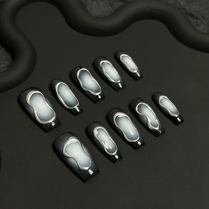 A press-on nail set featuring monochrome smoky gradients framed by reflective silver outlines, creating a minimalist and futuristic design.