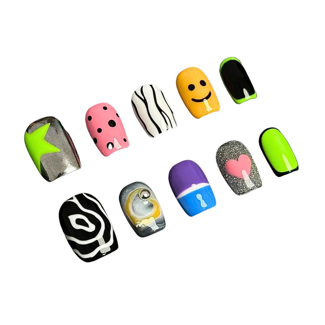 A press-on nail set featuring neon green, pink polka dots, smiley faces, abstract black-and-white patterns, and glitter accents, creating a playful and pop-art-inspired design.