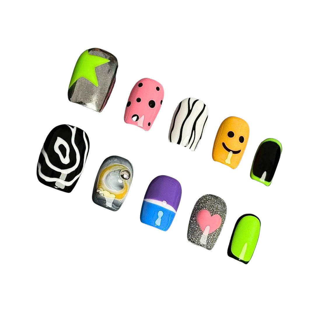 A press-on nail set featuring neon green, pink polka dots, smiley faces, abstract black-and-white patterns, and glitter accents, creating a playful and pop-art-inspired design.