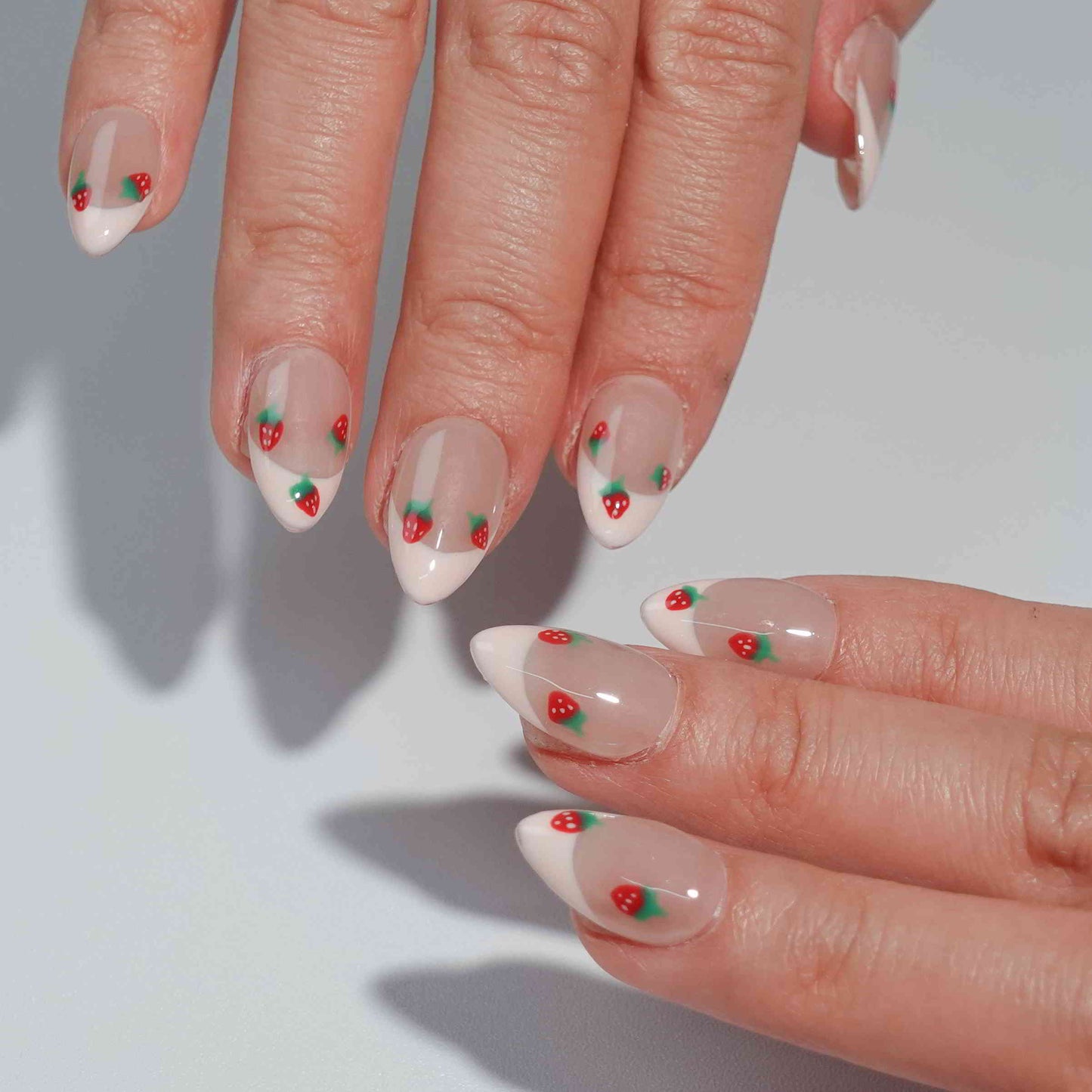 Nude nails with white French tips, beautifully decorated with dainty red cherries and green stems. This design captures the simplicity and elegance of a summer orchard, offering a graceful yet playful touch.