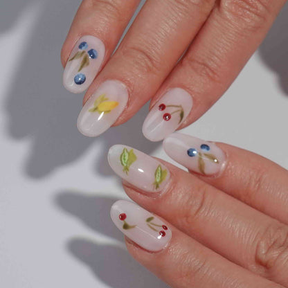 A set of press - on nails with colorful fruit illustrations including cherries, blueberries, carrots, lemons, and peas. The nails have a fresh and lively appearance, ideal for summer outings or fruit - themed parties.