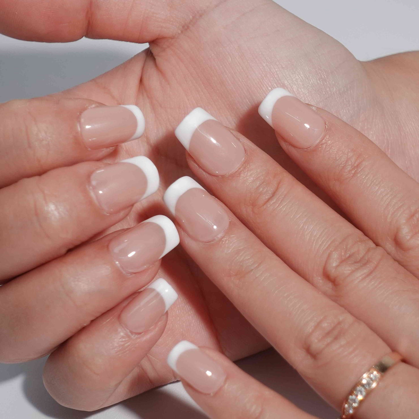 Square-shaped French nails with white tips and a nude base, delivering a clean and polished style perfect for various settings