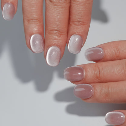 A set of rose - colored press - on nails with a subtle shimmer, neatly arranged in a transparent case. The nails have a soft, glowing finish, ideal for creating a romantic and elegant look, suitable for dates or special occasions.