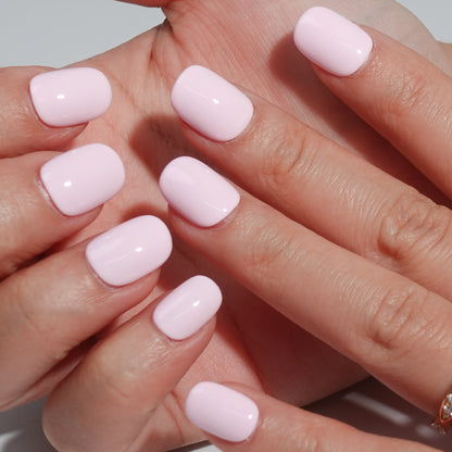 A set of light pink glossy press - on nails neatly arranged in a transparent case, featuring a gentle, smooth finish, ideal for romantic or feminine occasions.