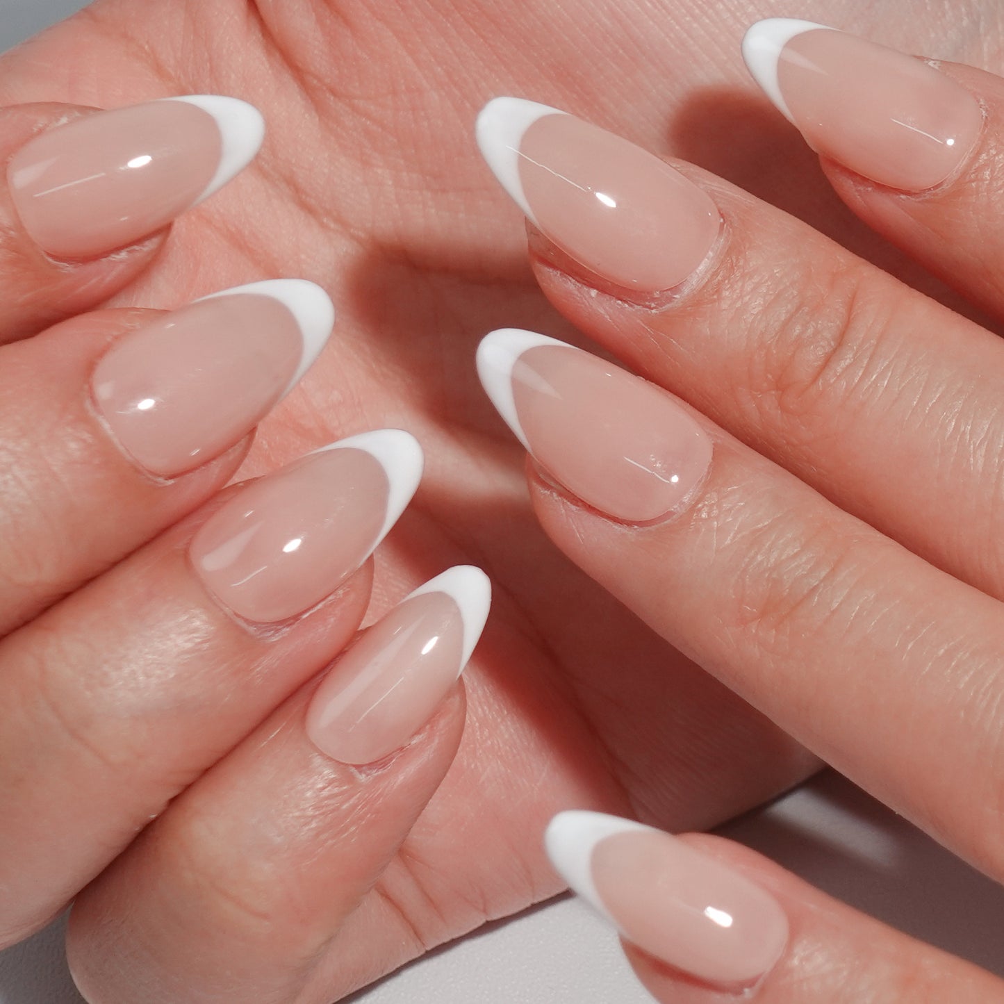 Ombre Glow nail set features a subtle ombre effect transitioning from deep smoky tones to light white tips, perfect for a sophisticated style.