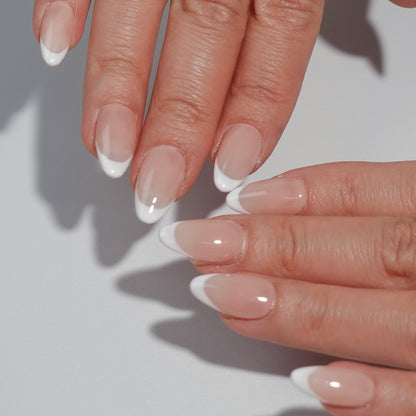 Ombre Glow nail set features a subtle ombre effect transitioning from deep smoky tones to light white tips, perfect for a sophisticated style.