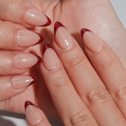 Deep brown French nails with almond-shaped design and smooth nude base, exuding noble elegance.