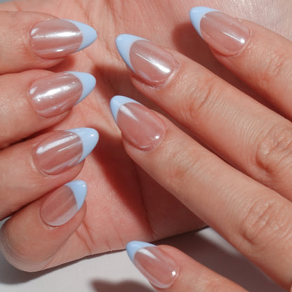 Light blue French nail design with a sparkling nude base and refined blue tips, creating a simple yet graceful visual effect.