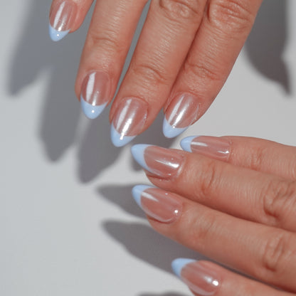 Light blue French nail design with a sparkling nude base and refined blue tips, creating a simple yet graceful visual effect.