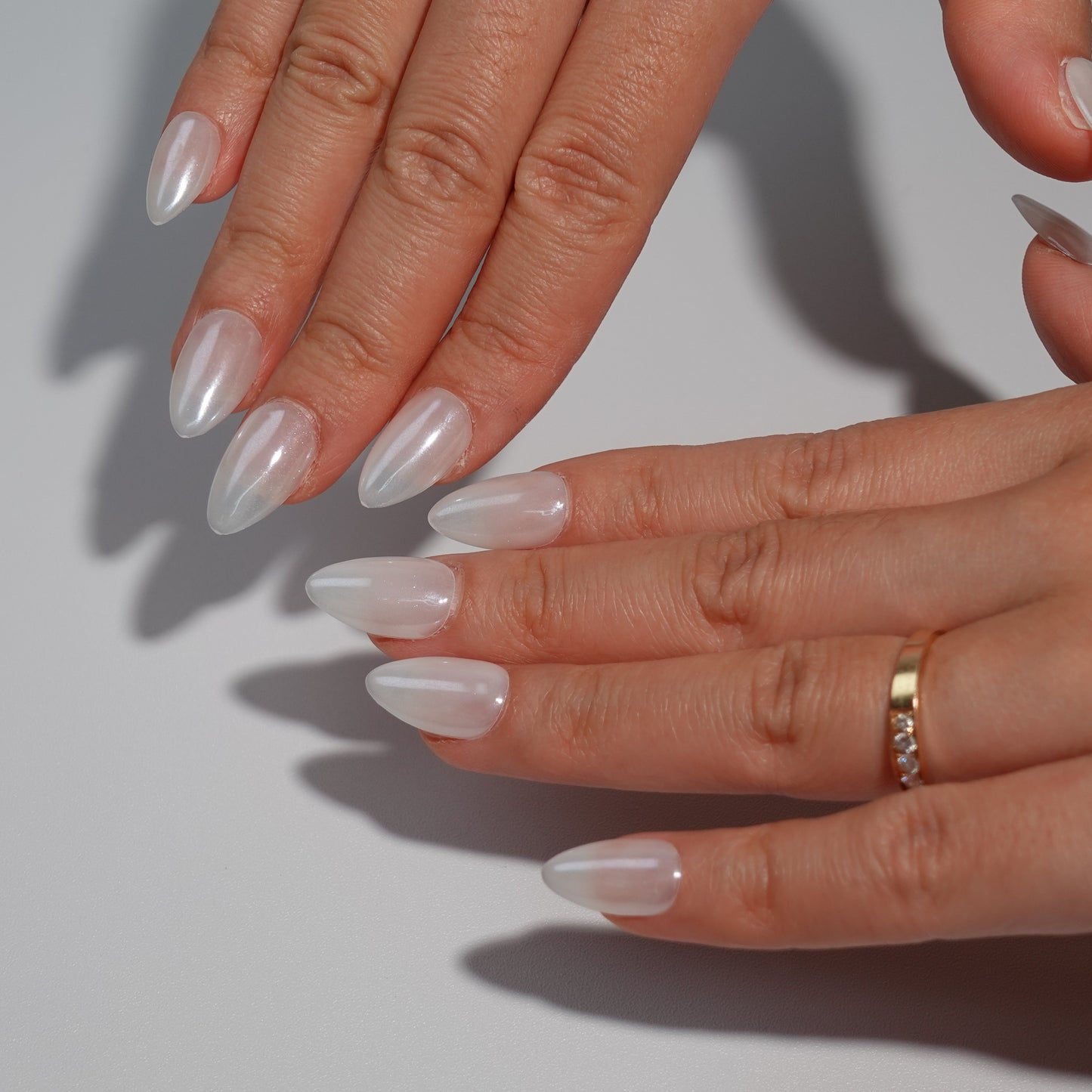 A luxurious press-on nail set with a smooth, pearly white finish, offering a refined and luminous design suitable for bridal looks and formal events.