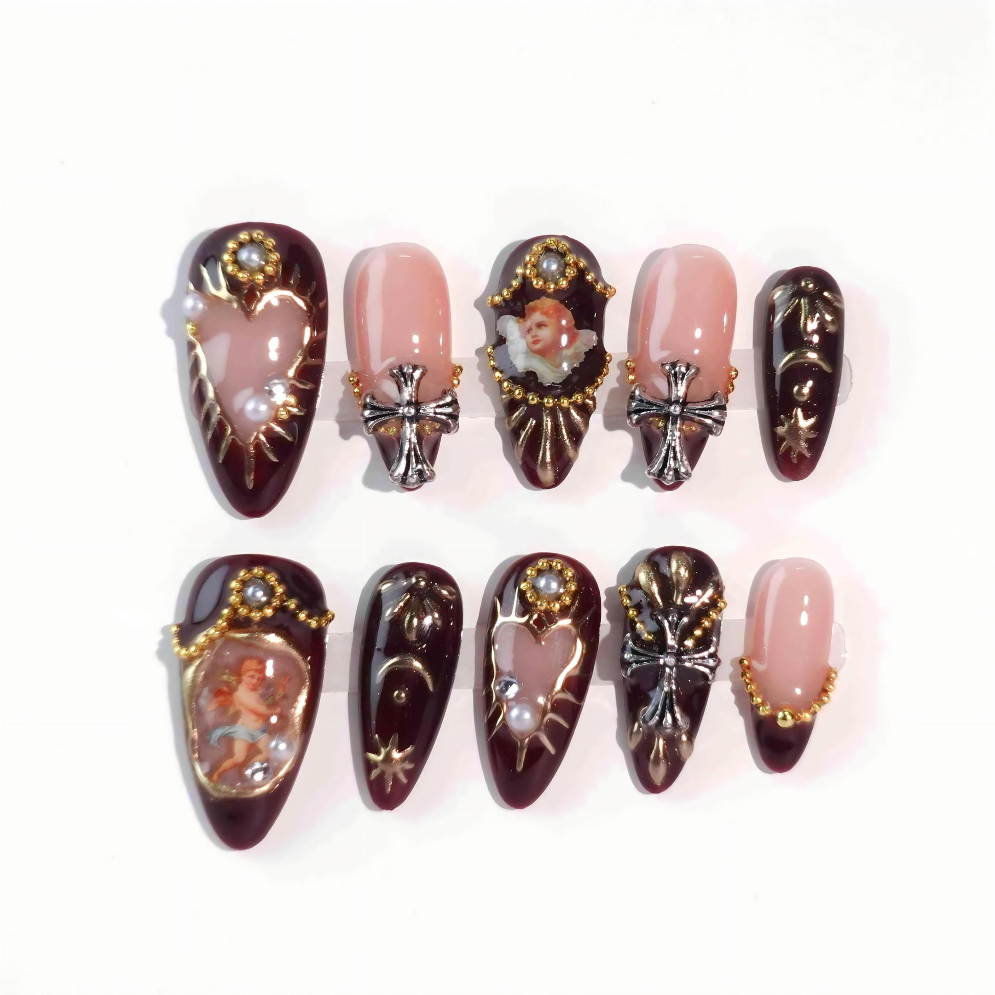 A luxurious set of burgundy press-on nails with golden details, pearl ornaments, hand-painted cherub motifs, and gothic-style crosses, evoking the grandeur and elegance of the Baroque era. Ideal for statement looks.