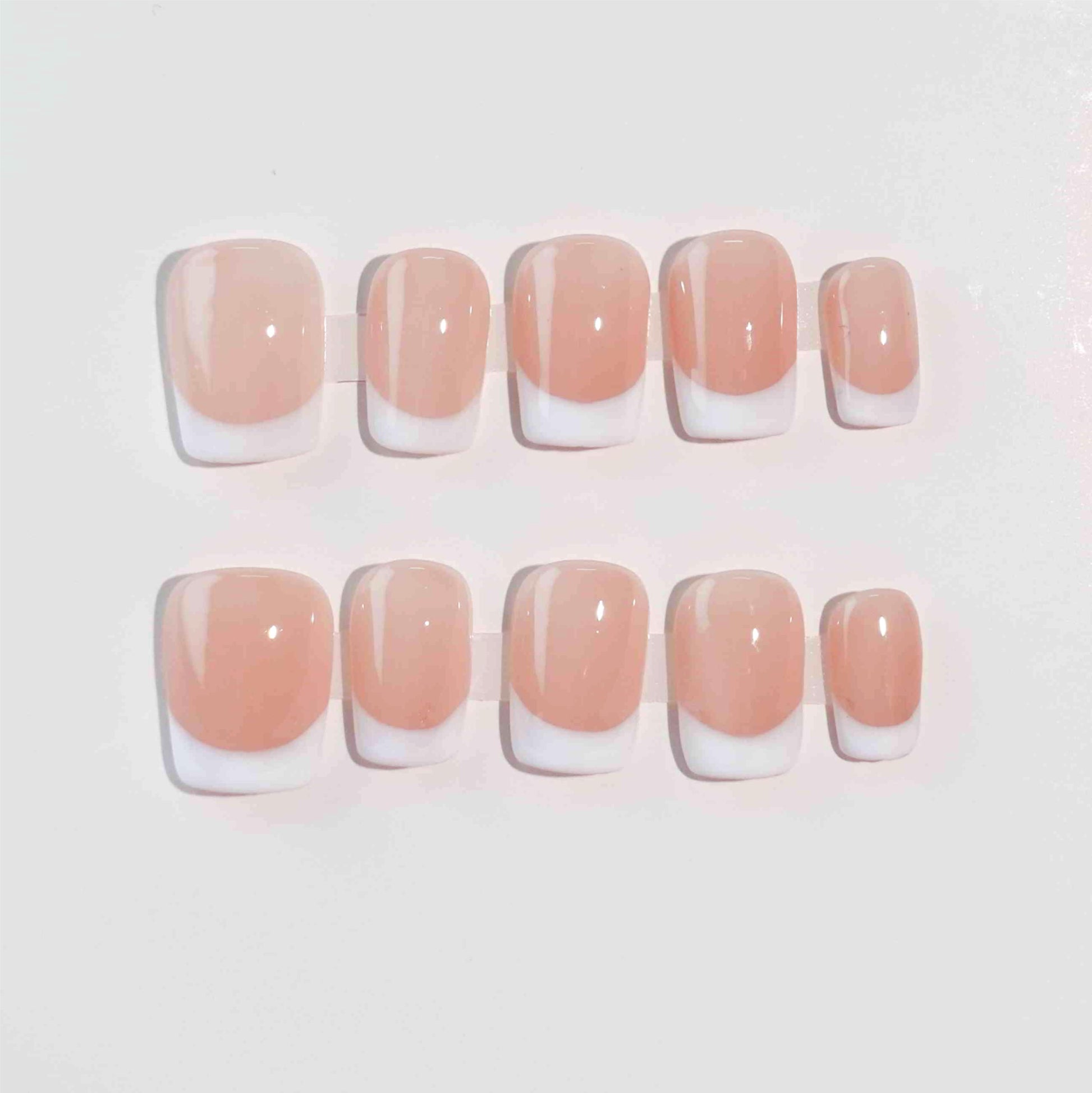 Square-shaped French nails with white tips and a nude base, delivering a clean and polished style perfect for various settings