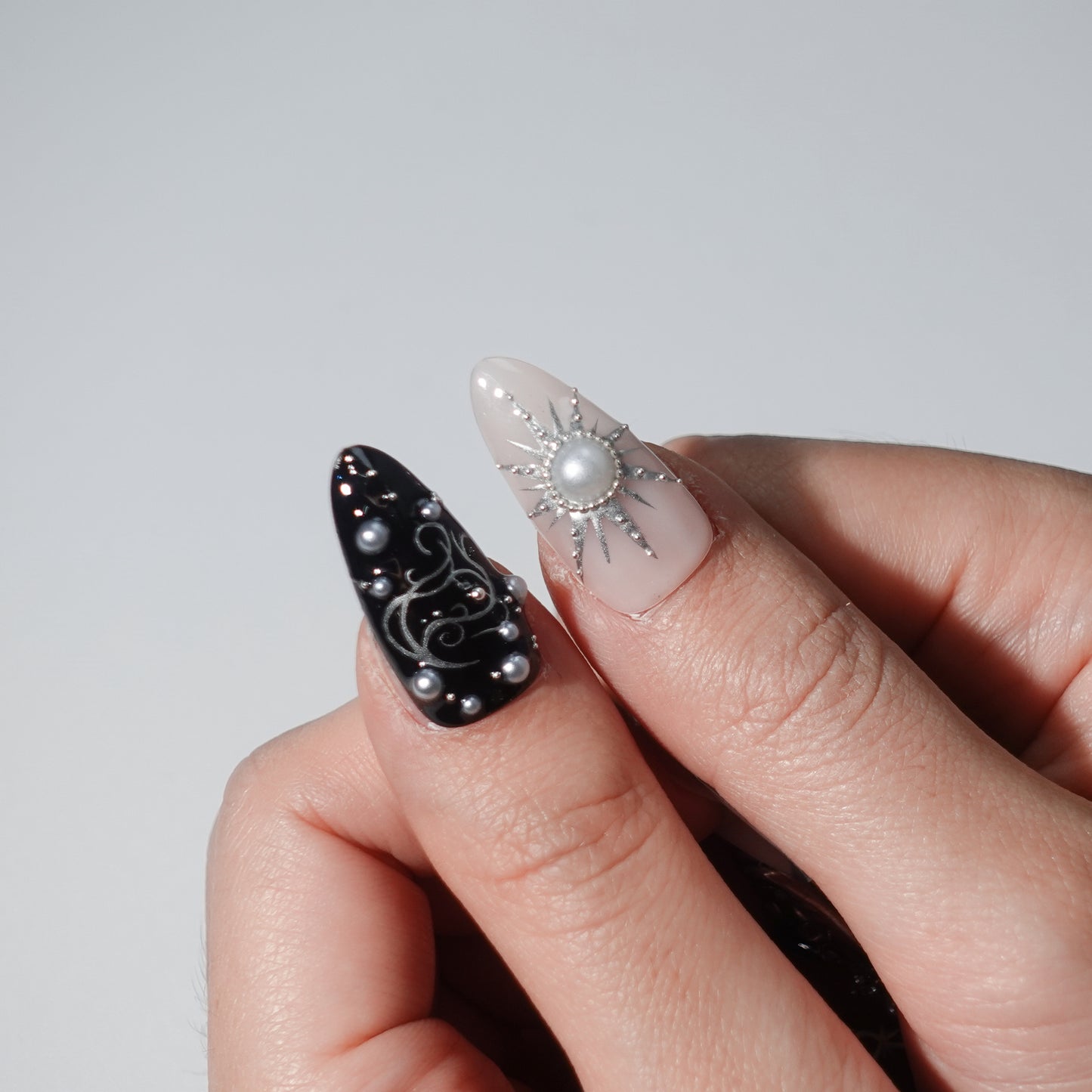 Press - on nails featuring dark hues, silver star - like accents, and a design that combines elements of Gothic style.