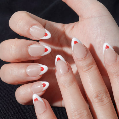 A romantic nail design named "Lovers’ Symphony," showcasing nude nails with soft red-to-white gradient French tips, each adorned with a perfectly placed red heart. This design evokes the tender harmony of love and connection, making it a perfect match for date nights or anniversaries.