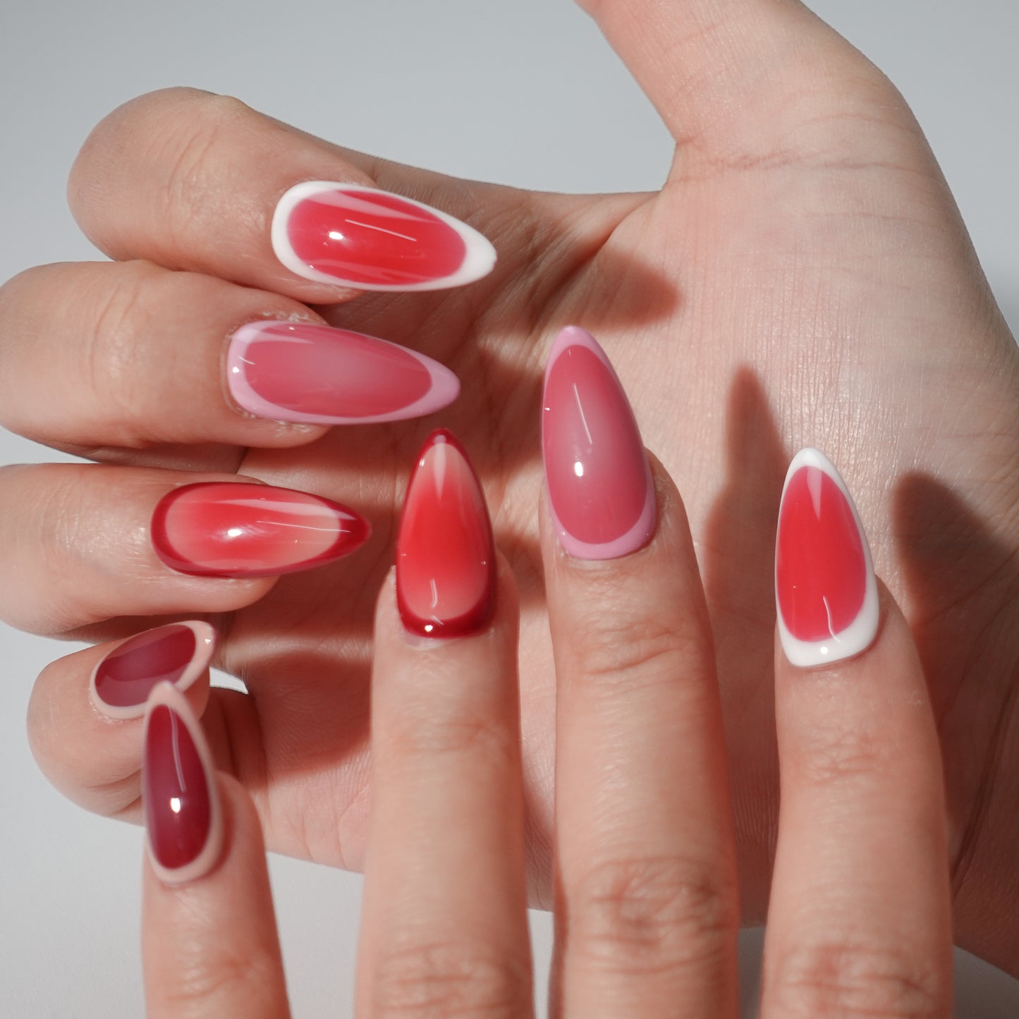 A set of press - on nails with a color gradient ranging from soft blush pink to rich berry red. The nails have a sophisticated and charming appearance, suitable for romantic evenings or formal gatherings.