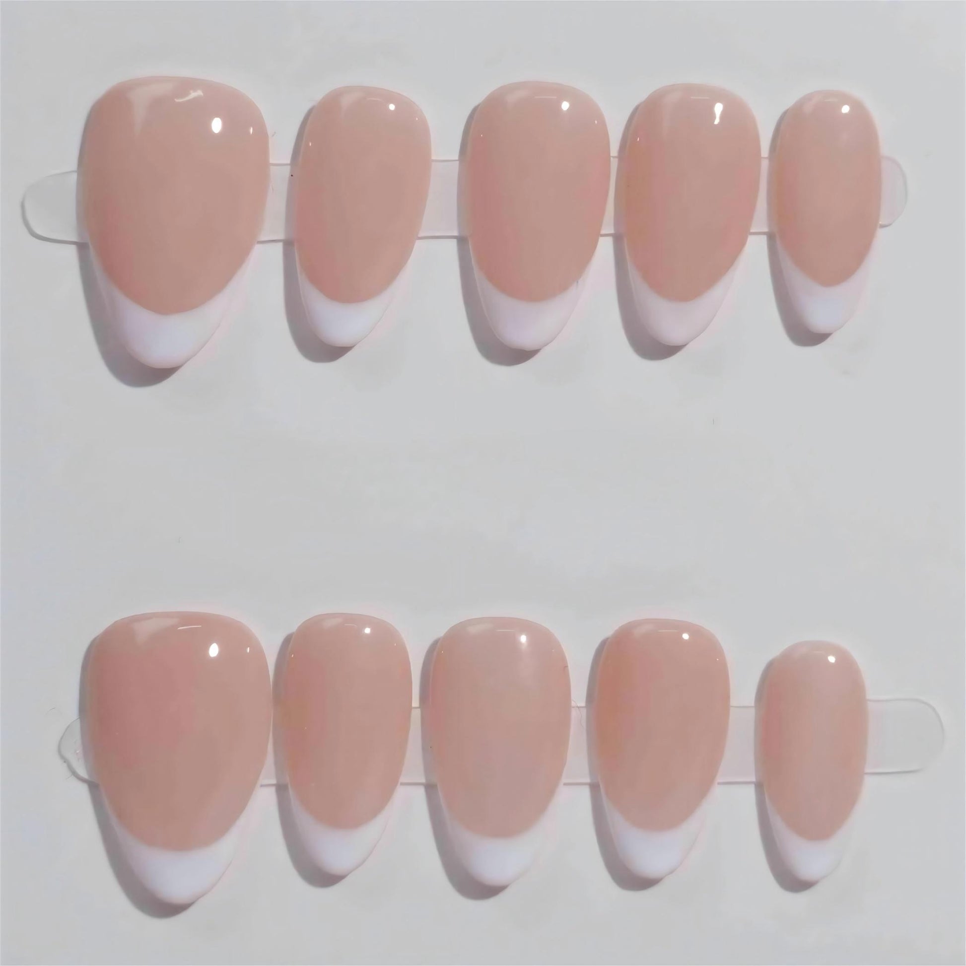 Ombre Glow nail set features a subtle ombre effect transitioning from deep smoky tones to light white tips, perfect for a sophisticated style.