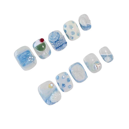 A captivating set of press-on nails in calming blue tones, featuring ocean-inspired designs such as seashells, delicate waves, and shimmering pearl details. Ideal for embracing a tranquil and sophisticated style.